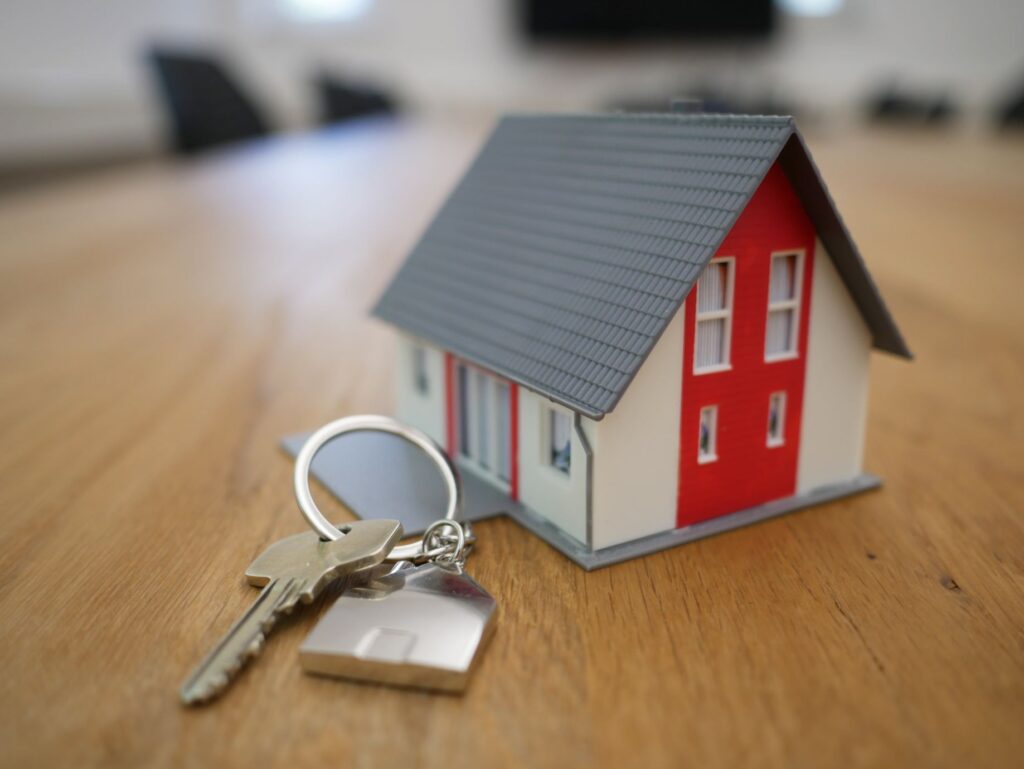 A model house next to a set of keys