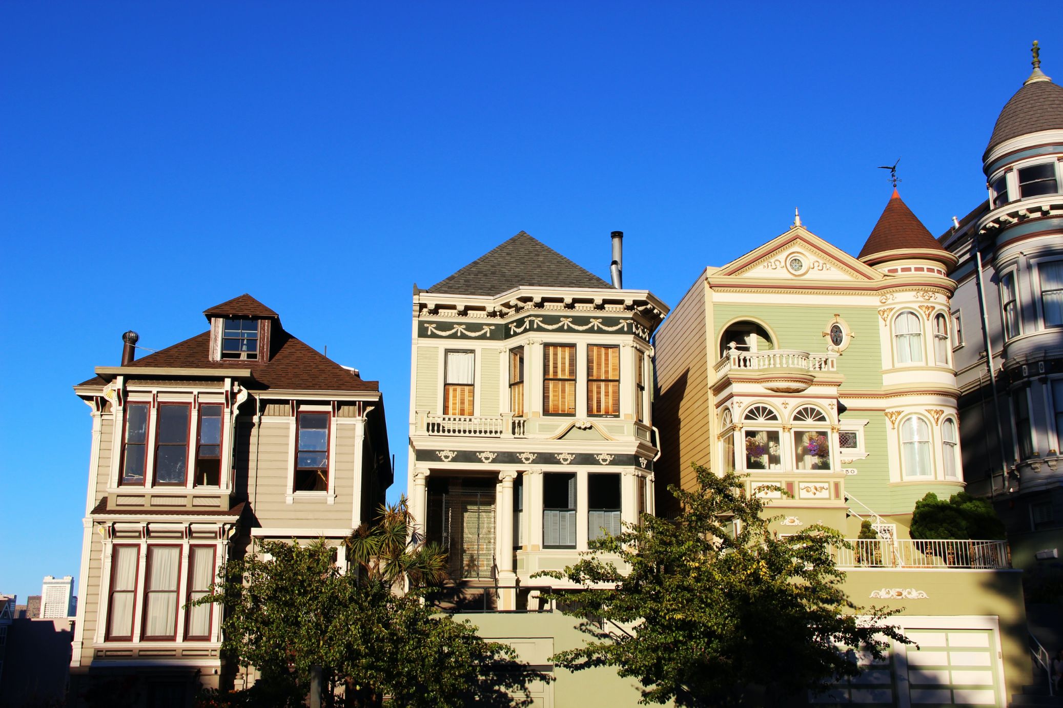 A row of American houses with porches against a blue sky