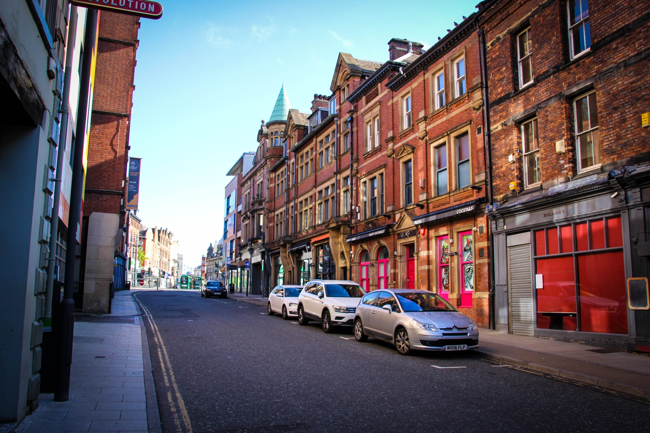 A street of terraced houses on a road in the UK