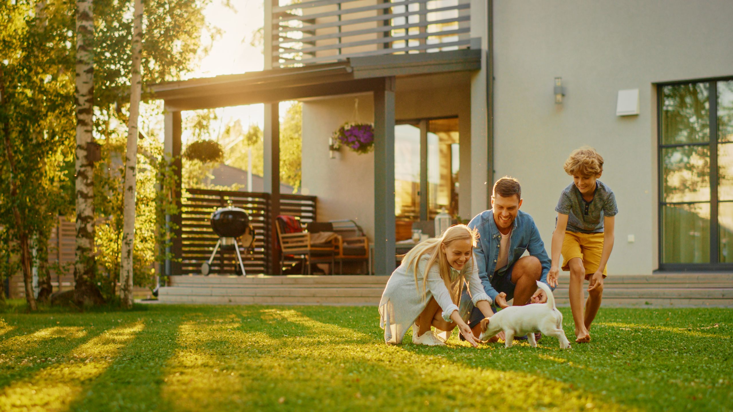 A family playing in the garden of a new build home